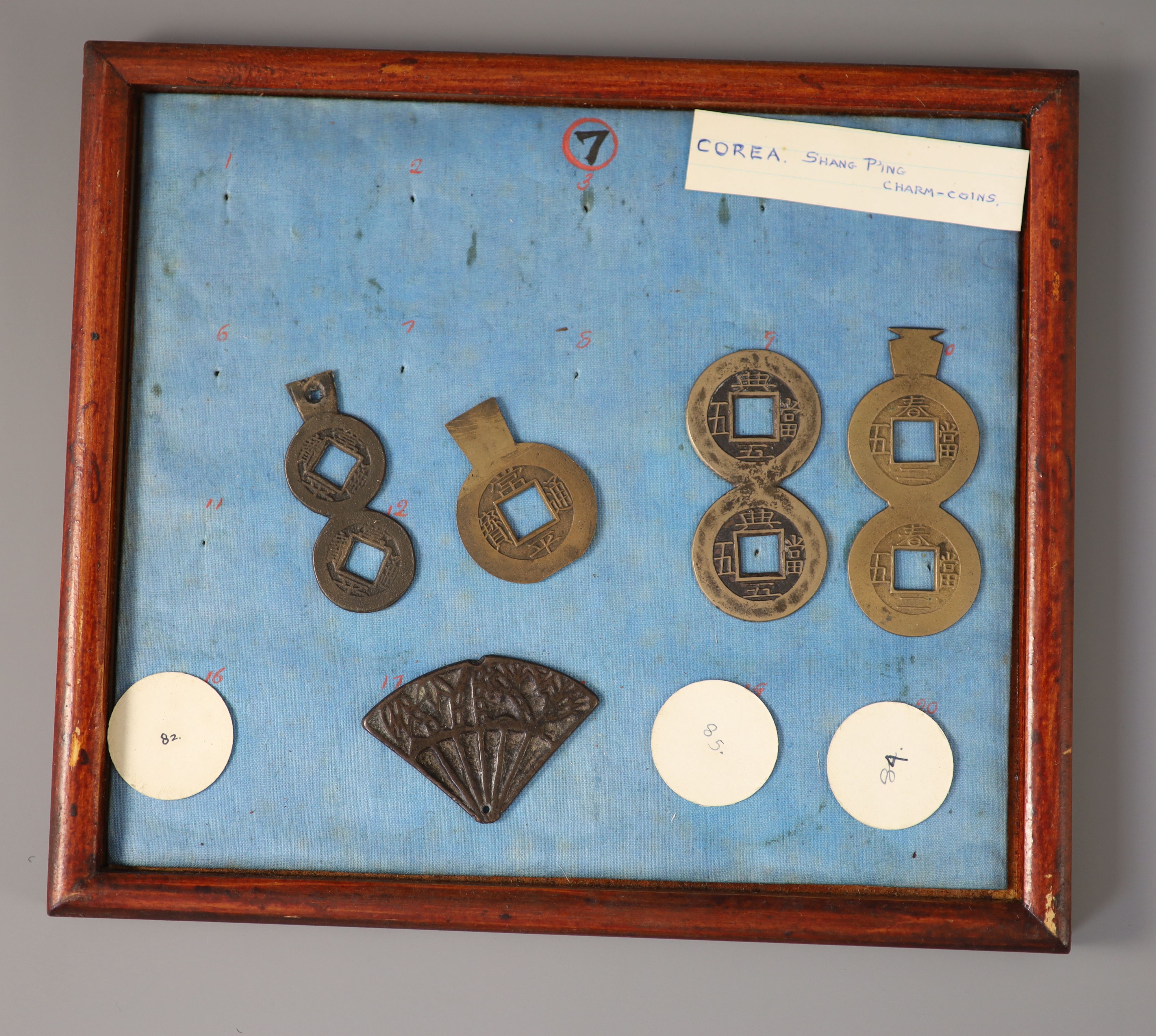 A group of 99 Korean bronze and metal amulets or charms, 19th/20th century